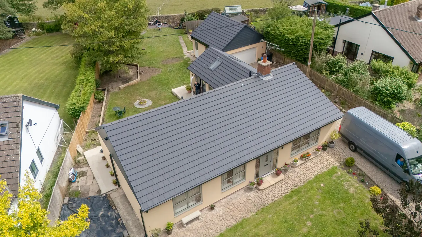 Completed full bungalow re-roof with clean hips and valleys, aerial view